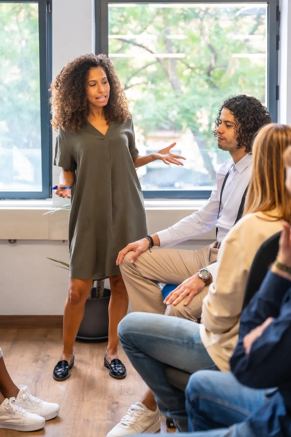 A woman speaking to her team in a bright office